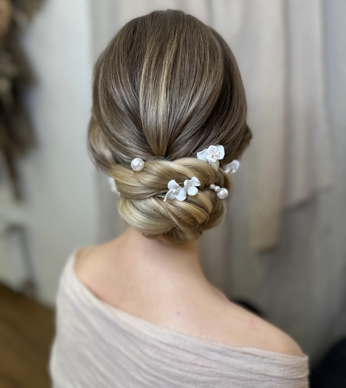 Elegante Brautfrisur mit Perlen und weißen Blüten