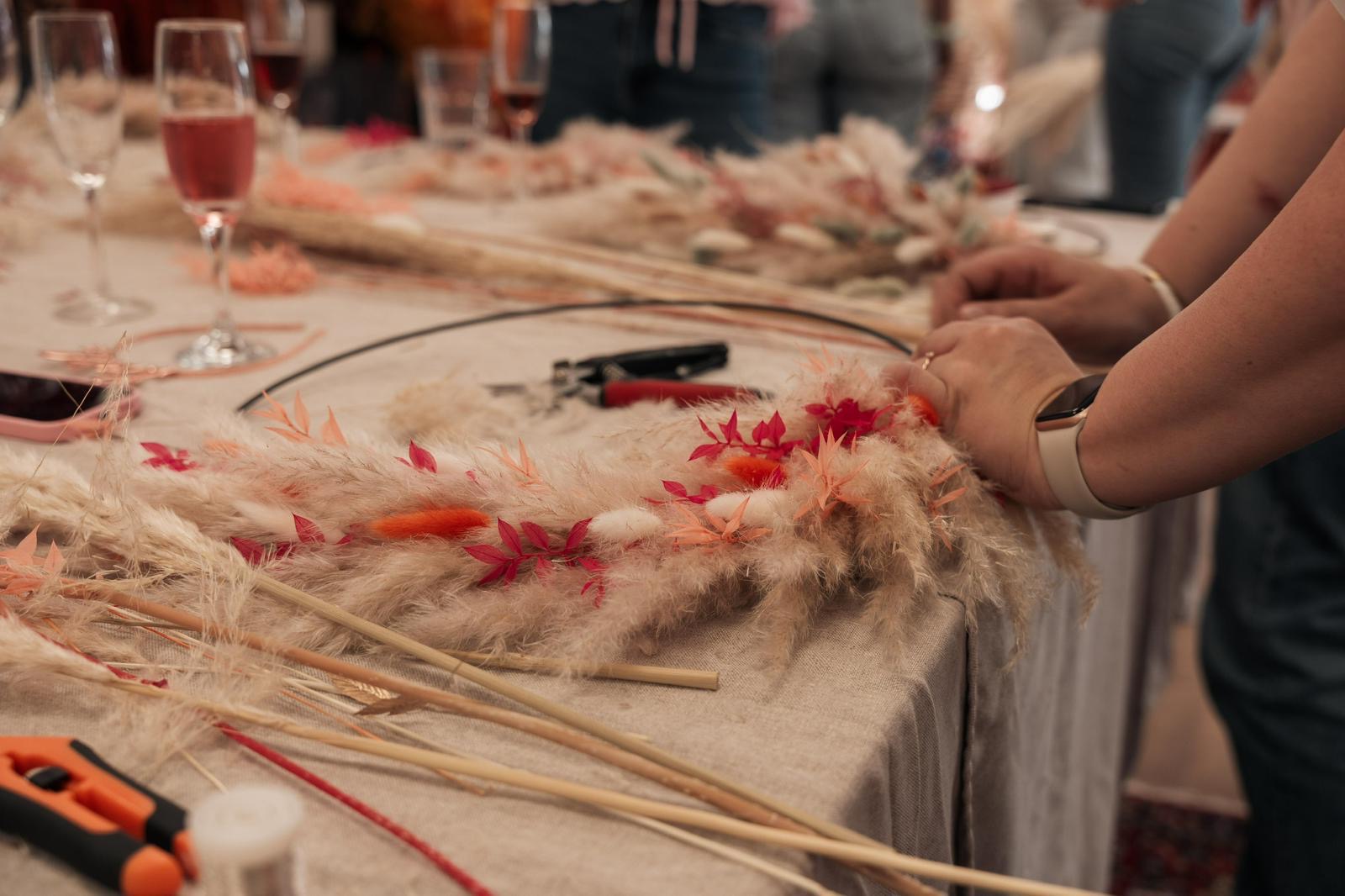 Trockenblumen und Werkzeuge auf dem Workshop-Tisch